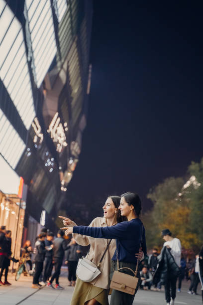 istock two female friends walking in downtown Beijing 1246872393
