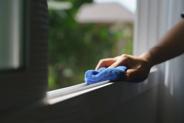 Hand holding microfiber cloth for cleaning Hand holding blue microfiber cloth for cleaning dust on the glass window rail window frame stock pictures, royalty-free photos & images