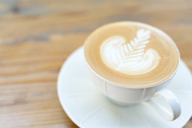 Cup of coffee with latte art pattern milk foam