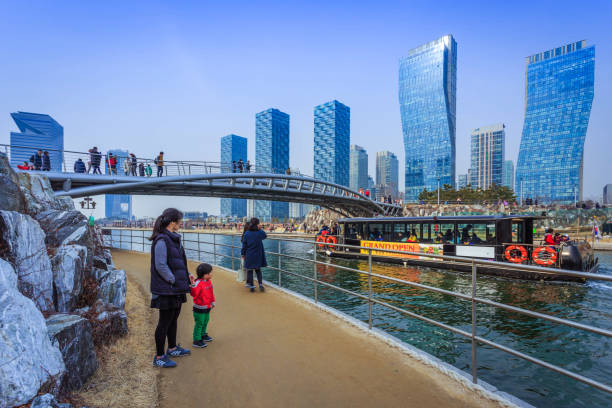 People are riding a tourist boat in summer of Korea at Central Park in Songdo District, Incheon South Korea. Incheon, South Korea - March 08, 2015: People are riding a tourist boat in summer of Korea at Central Park in Songdo District, Incheon South Korea. songdo ibd stock pictures, royalty-free photos & images
