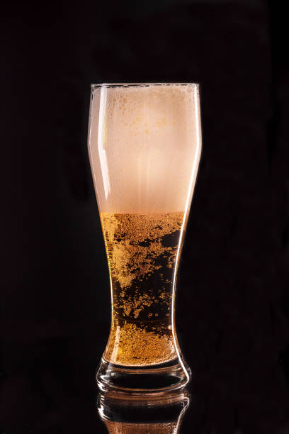 istock Glass of light beer on a dark background 1246905808