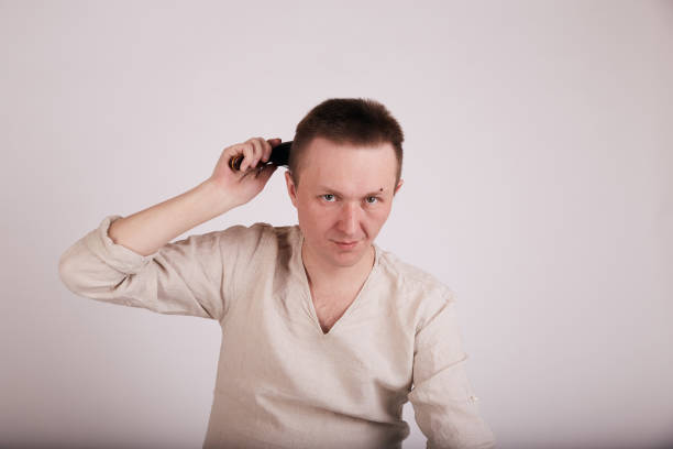 istock Man doing haircut by himself at home while Covid-19 quarantine. Self isolation lifestyle 1246906117