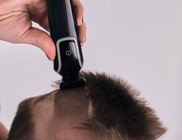 istock Man doing haircut by himself at home while Covid-19 quarantine. Self isolation lifestyle 1246906784