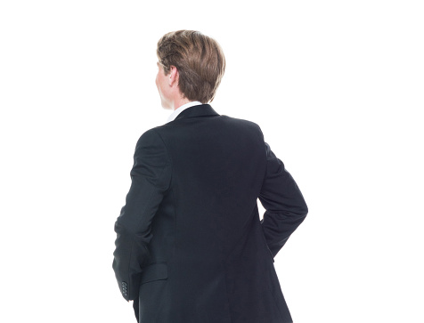Rear view of a businessman crosses his fingers behind his back. Vertical shot. Isolated on white.