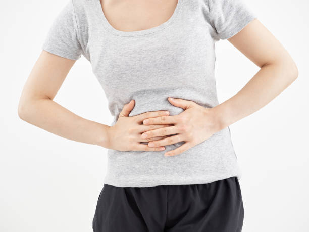 istock Woman holding a stomach ache with white background 1246907205