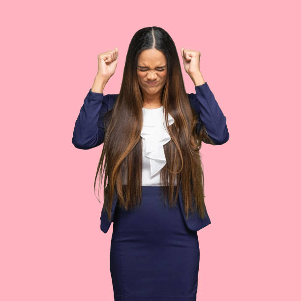African-american ethnicity young women manager standing in front of colored background wearing blazer One person of aged 30-39 years old who is beautiful with long hair african-american ethnicity young women manager standing in front of colored background wearing blazer who is embarrassed embarrassment skirt photos stock pictures, royalty-free photos & images