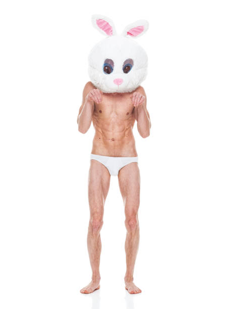 caucasian male standing in front of white background wearing mask - disguise - shirtless men bizarre male imagens e fotografias de stock