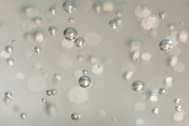 A selective focus shot a abstract background of glowing and iridescent bubbles. Blurred background