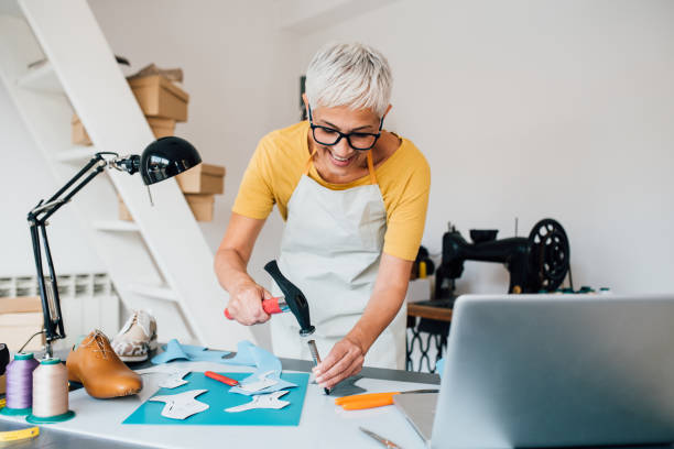 istock Mature woman making leather shoes at her workshop 1246912195