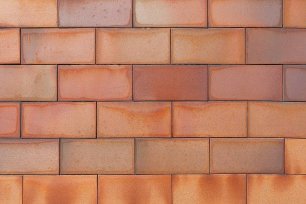 istock Brick tiled brown old wall made of symmetrical blocks 1246914484