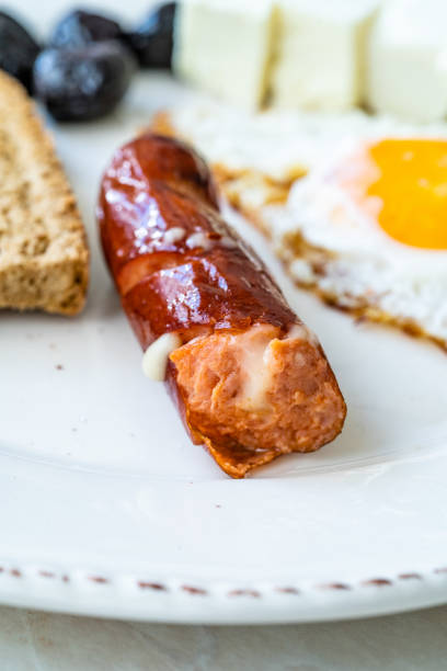 istock Bratwurst Sausage Filled with Emmental Cheese in Breakfast Plate. 1246916135
