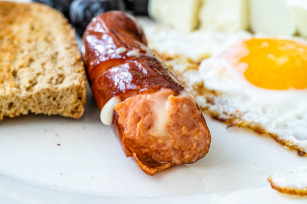 istock Bratwurst Sausage Filled with Emmental Cheese in Breakfast Plate. 1246916162