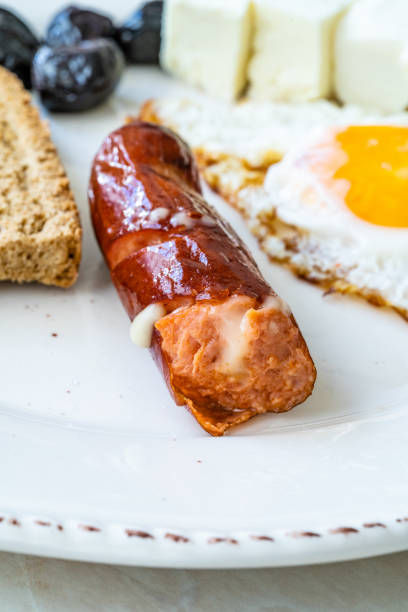 istock Bratwurst Sausage Filled with Emmental Cheese in Breakfast Plate. 1246916213