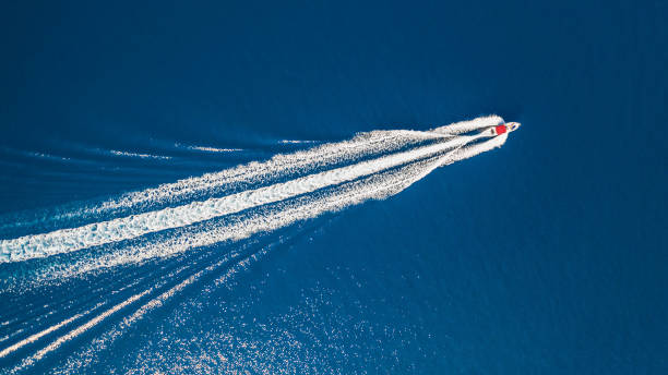 istock Top down view on fast motorboat, which is leaving foam track on water surface. 1246920821
