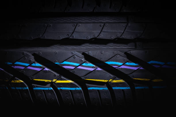istock Black's tire tread detail in studio shoot made on dark background tone. 1246920872