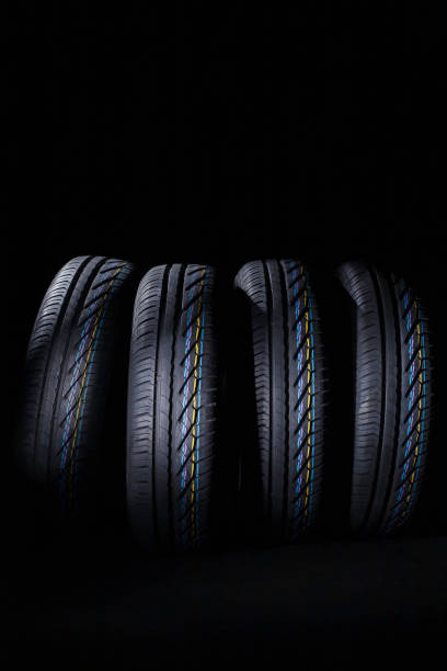 istock Black's tire tread detail in studio shoot made on dark background tone. 1246921563