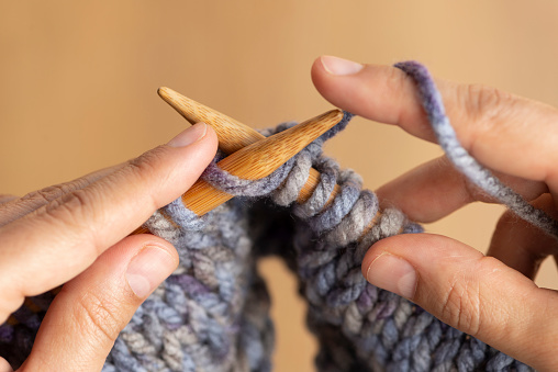 Close up on woman's hands knitting.