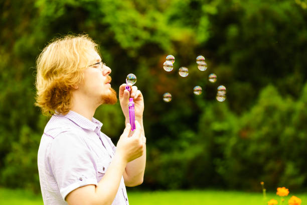 istock Man blowing soap bubbles outdoor 1246921719