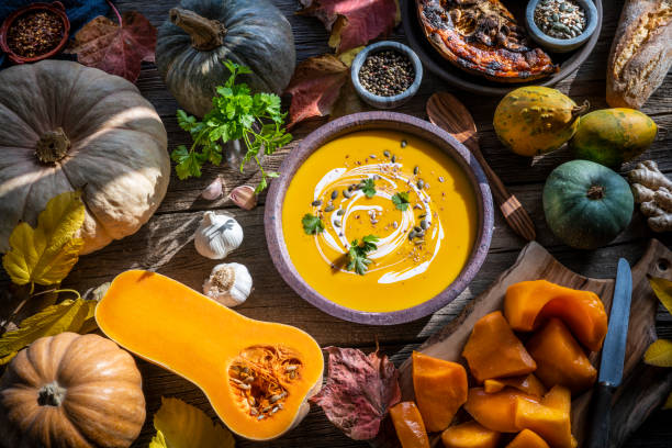 istock Autumn pumpkin soup and ingredients on wood 1246932003