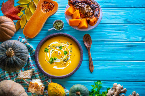 istock Autumn pumpkin soup and ingredients on turquoise 1246932220