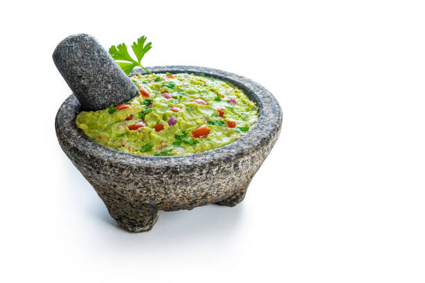 guacamole avocado mexican recipe in stone molcajete isolated on white - guacamole avocado mexican culture food imagens e fotografias de stock