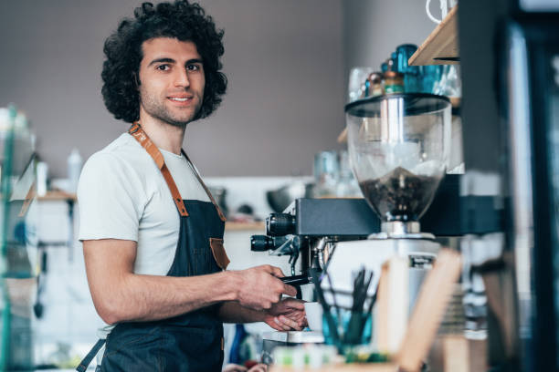 istock Male barista making coffee 1246944747