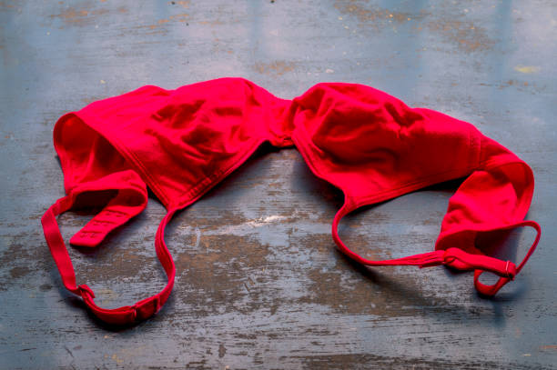 red bra on rustic metallic floor. sexy fashion background. still life. - panties lingerie sensuality bra imagens e fotografias de stock