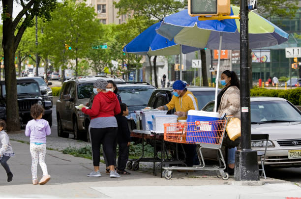 Food vendor sells food outdoors during COVID-19 pandemic Bronx NY stock photo