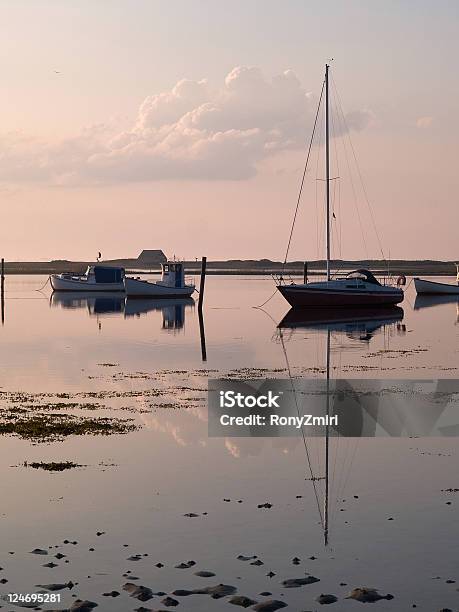 Sail Boats Reflected In The Ocean Stock Photo - Download Image Now - Anchored, Beach, Coastline