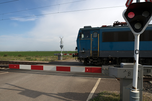 a modern intercity train go through a railway crossing