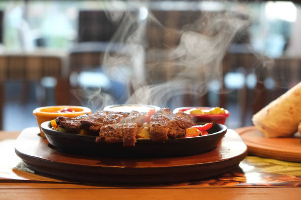 fajitas tomatoes and pepper are in the griddle