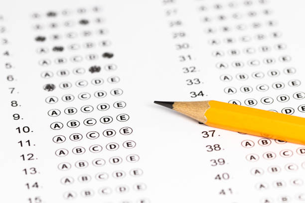 istock Answer sheet form with pencil on table, close up. Concept of passing exam 1246963254