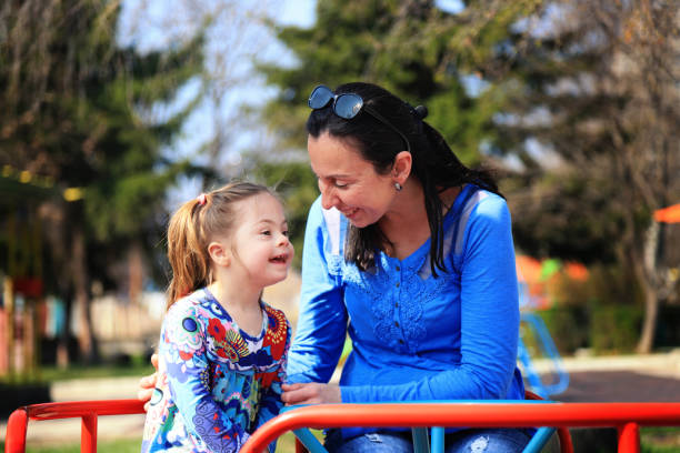 istock Mother and her daughter having fun in a playground 1246963834