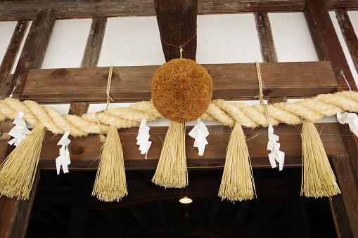 Aichi ,Japan – May 31 2020:This ball is Sugitama.This is a seasonal scene in Japan. It is hung in the space under the eaves of the sake brewery to announce that new sake has been produced. Sugitama is a craft made from collection of Cedar leaf and shaped into a ball. The Sugitama that is newly hung is fresh and green, but eventually withers to brown. This change in color tells people how much sake is aging.