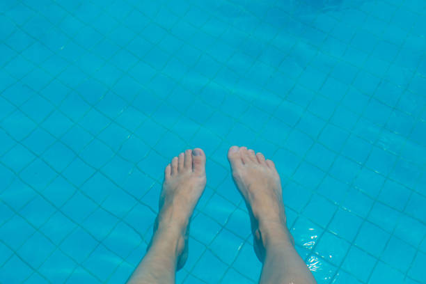 istock Feet in swimming pool 1246968484
