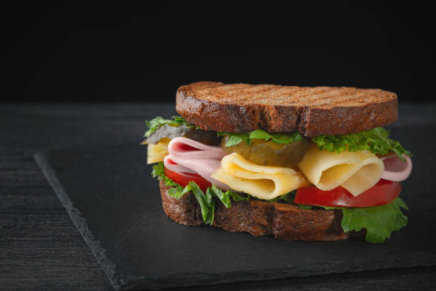 istock Sandwich with ham, cheese, tomatoes, lettuce, and toasted bread. 1246976272