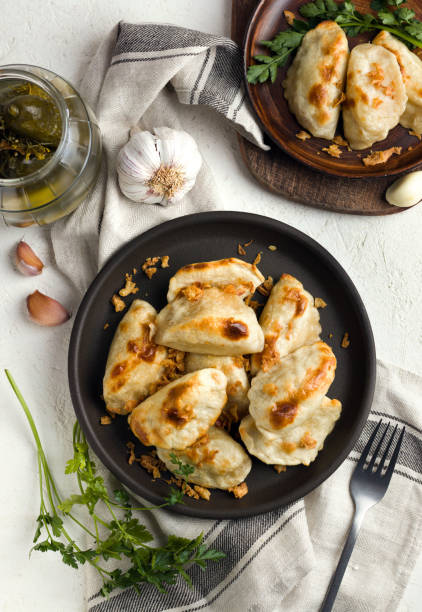 Polish traditional cuisine dumplings with potatoes. Serving top view flatlay Polish traditional cuisine dumplings with potatoes two plates. Serving top view flatlay pierogi stock pictures, royalty-free photos & images