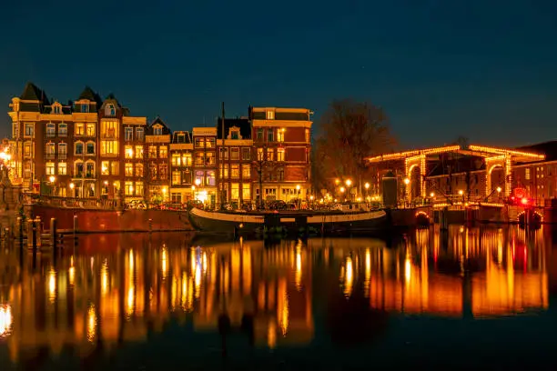 Photo of City scenic from Amsterdam at the river Amstel  in the Netherlands at night