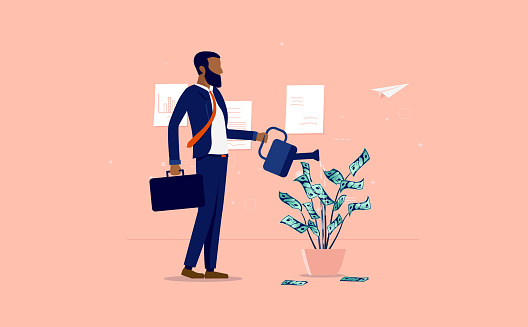 Money growth - Ethnic businessman watering a plant of dollar bills in office