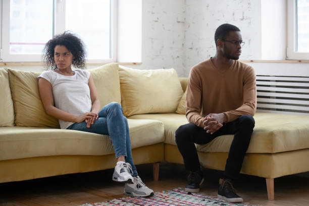 istock Dissatisfied American couple sitting apart having relations problems 1246980221