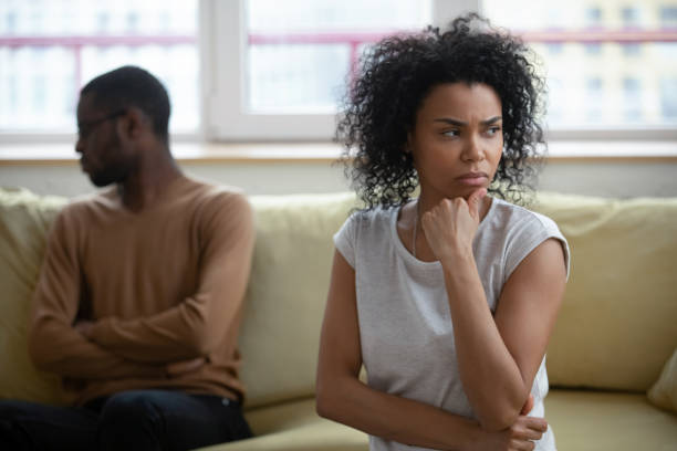 istock African couple sitting apart thinking about relations problems 1246980225
