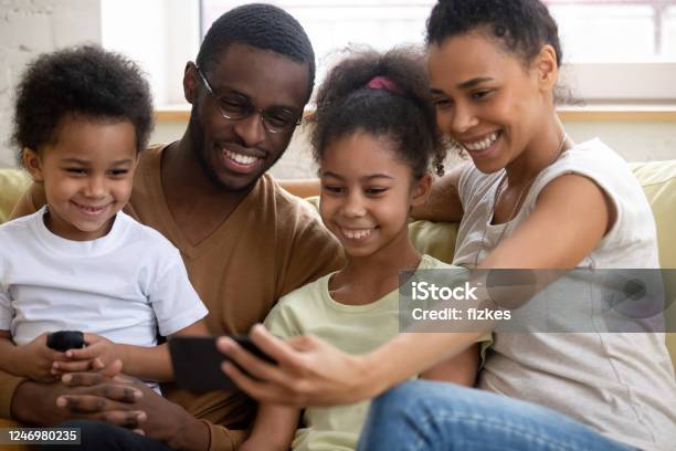 African Family With Kids Watching Funny Videos On Smartphone Stock Photo -  Download Image Now - iStock