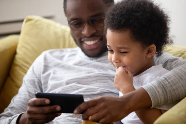 istock American dad spend time with little son using smartphone 1246980263