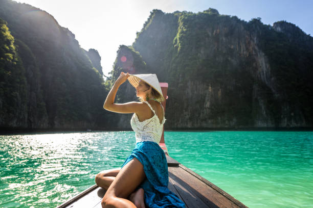 istock Beautiful woman on a long-tail boat in Thailand 1246980296