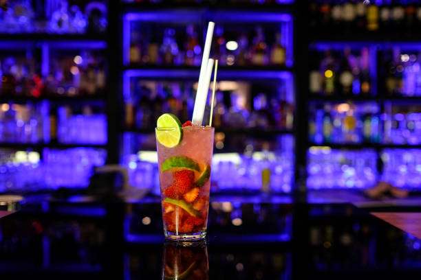 alcohol coctail on the bar focus on foreground with fruit