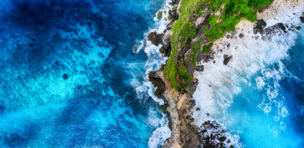 istock Waves and rocks as a background from top view. Blue water background from top view. Summer seascape from air. Bali island, Indonesia. Travel - image 1246981538