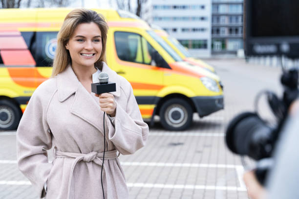 istock Smiling news reporter speaking into a microphone 1246984767