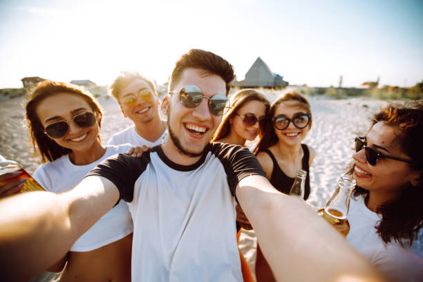 istock Group of young friends taking selfie and having fun on the beach. 1246997085