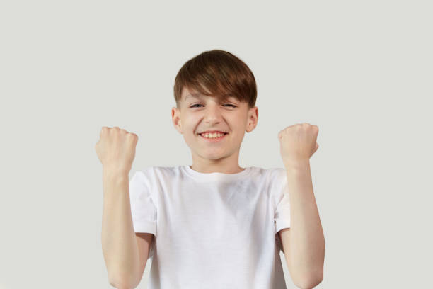 istock Joyful boy rejoices in victory with a broad smile on his face. 1246997768