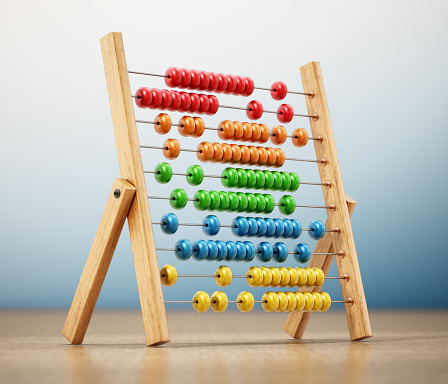 Abacus with colorful beads isolated on white with soft reflection.